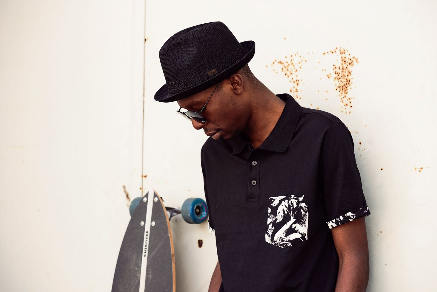 young man wearing multi coloured camo baseball cap displayed by the hat culture